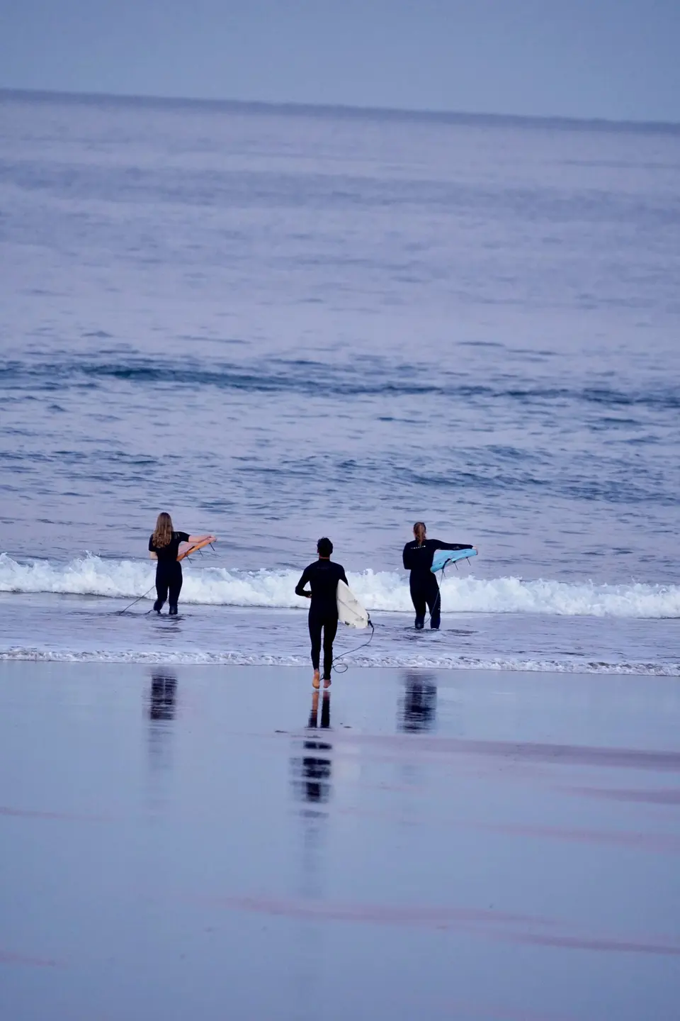 Surf camp group walking into the ocean