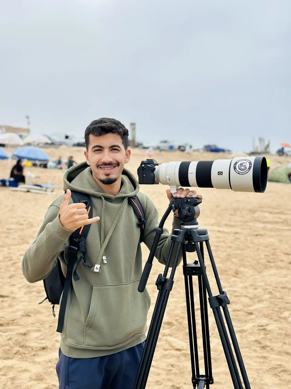 Khalil holding his camera on the beach in Taghazout