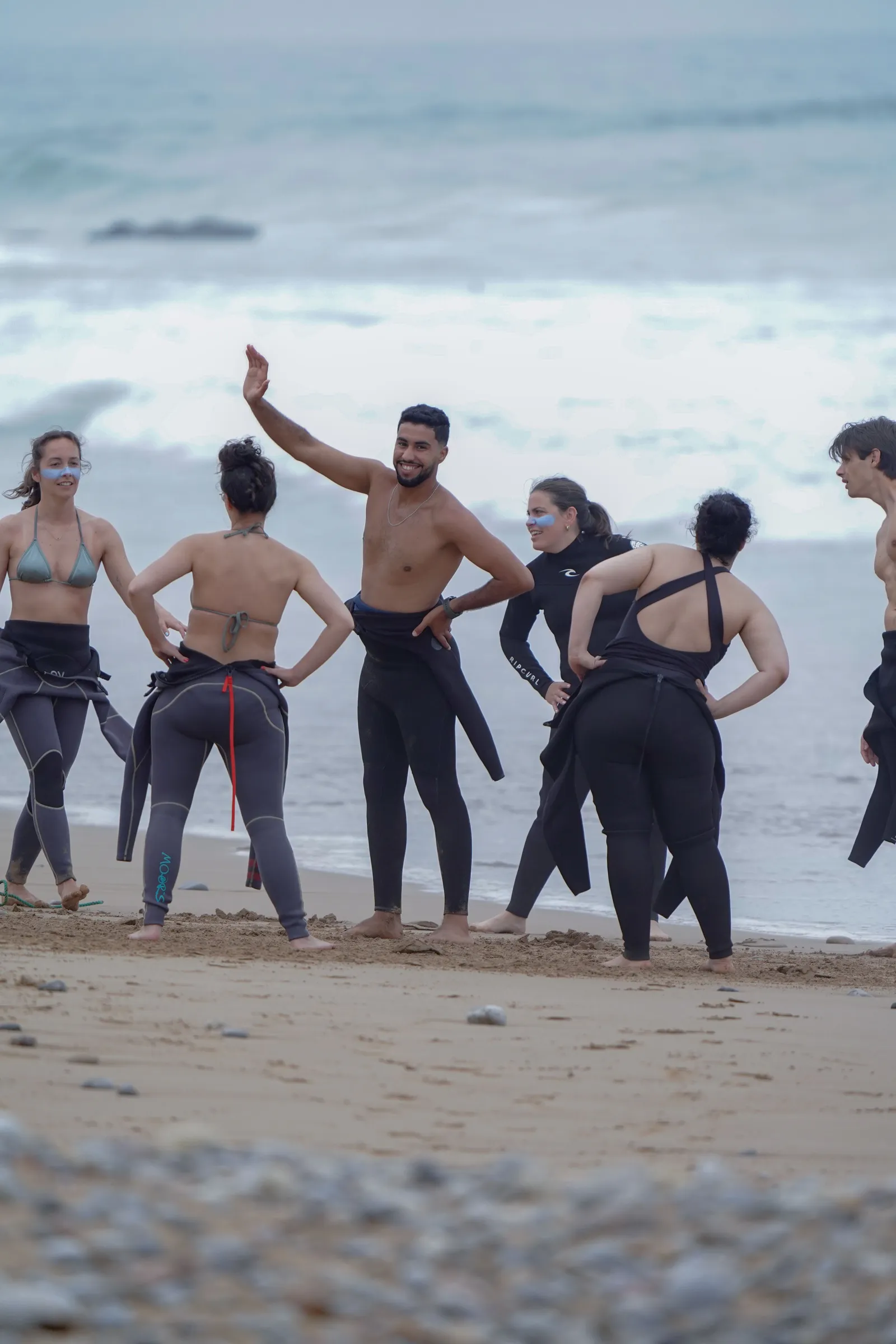 Group surf session near the beach with friends laughing