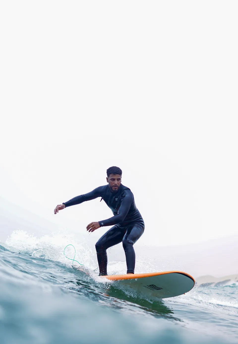 Surfer trimming smoothly along a peel on an orange board
